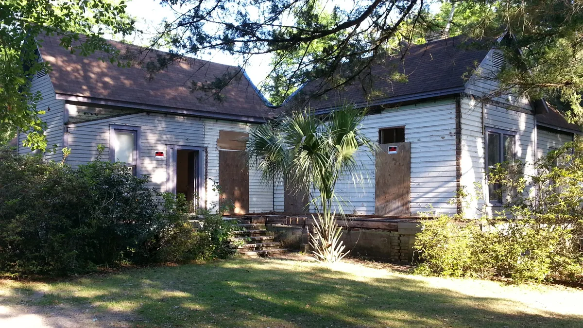 Older wood-sided Chipley house with its porch removed during deconstruction.