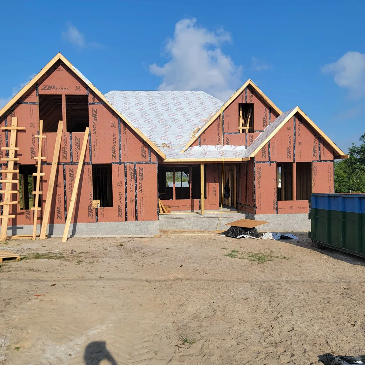 Front of the house framed and sheathed in ZIP System panels, with roof underlayment in place.