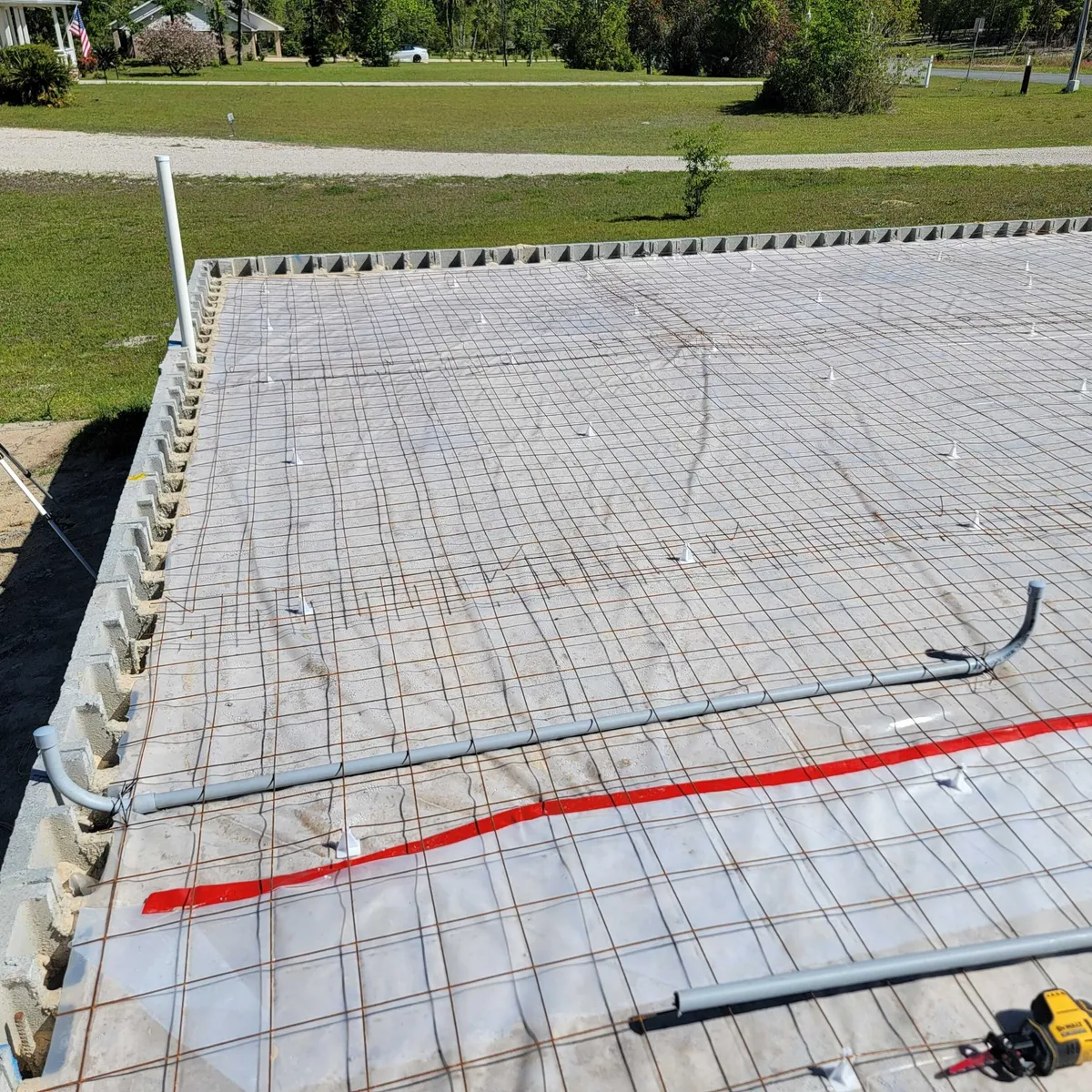Vapor barrier and wire mesh inside the stemwall, with electrical conduit laid across before the pour.