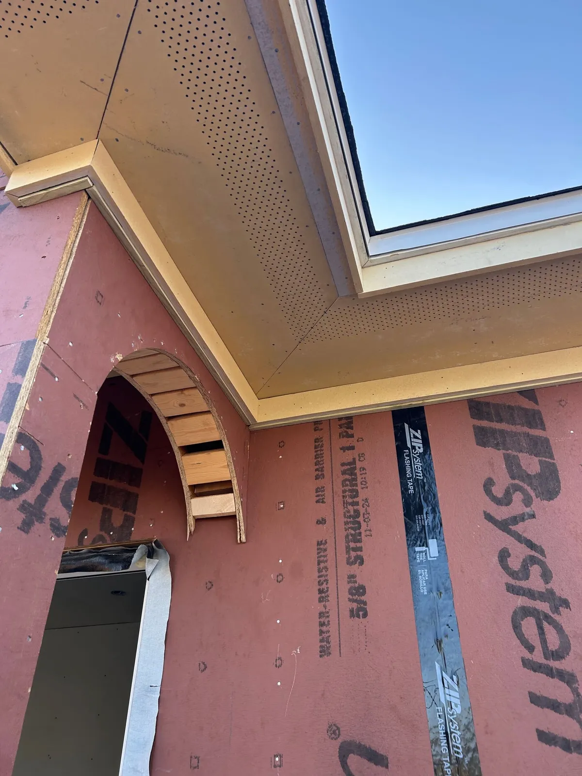 Framed arch ribs at the top of an opening, beneath the soffit and fascia.