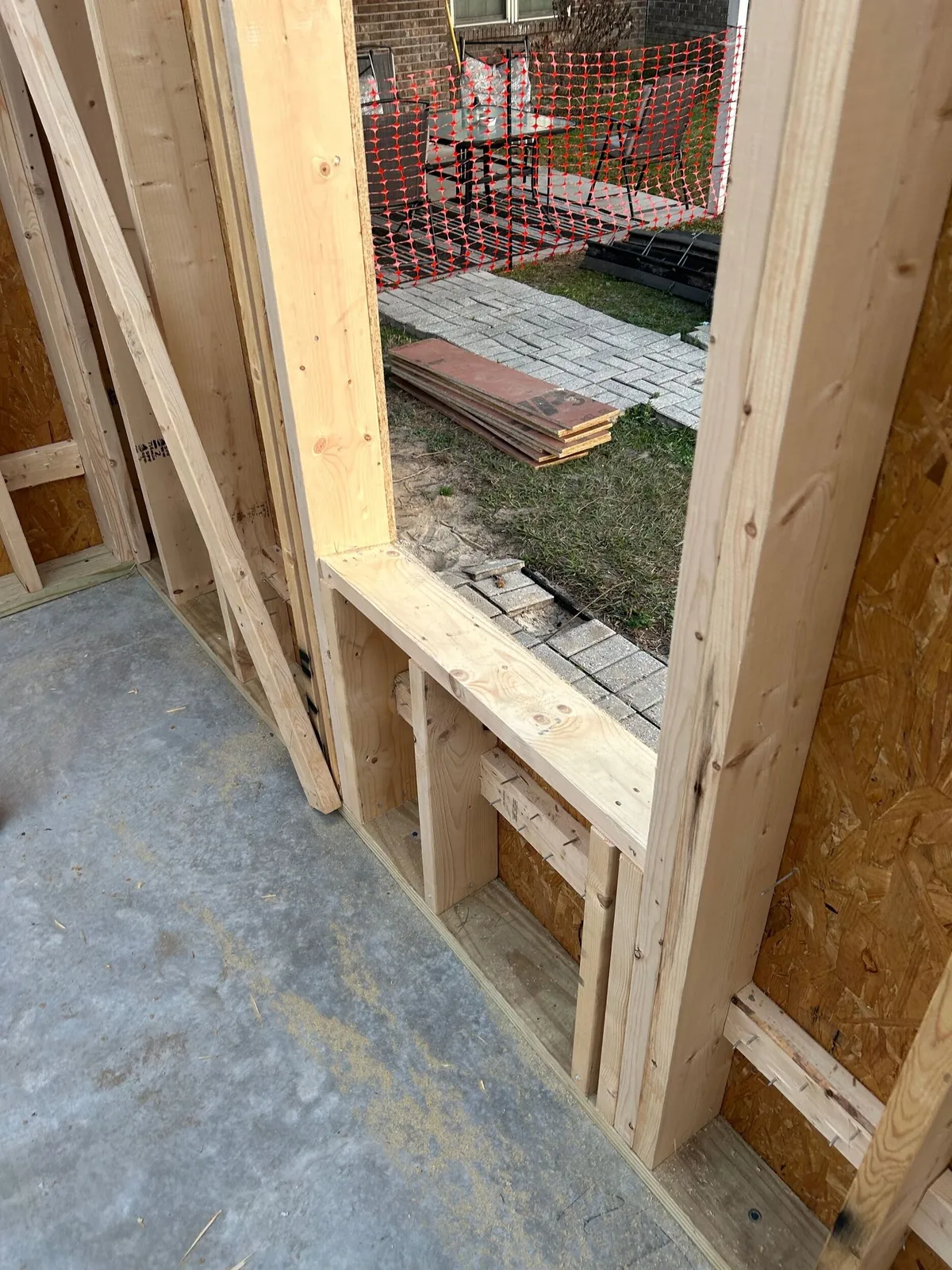 Framing at a window opening, showing the deep framed sill and angled studs that form the recess.